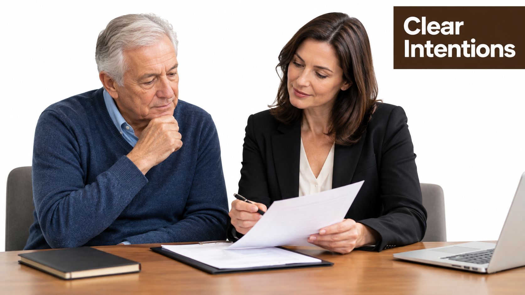 A professional financial advisor reviews a document with an older man sitting at a desk.